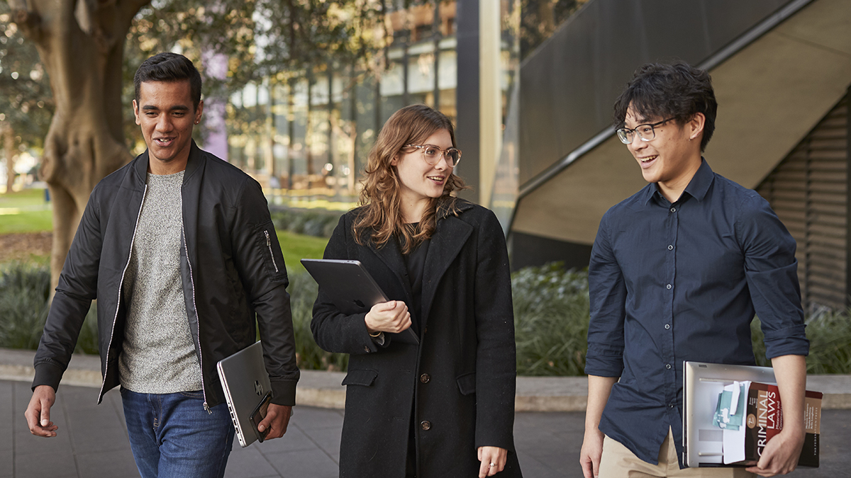 Three students walking and talking