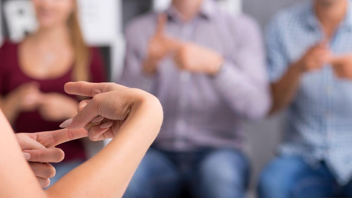 Close up of hands communicating using Auslan