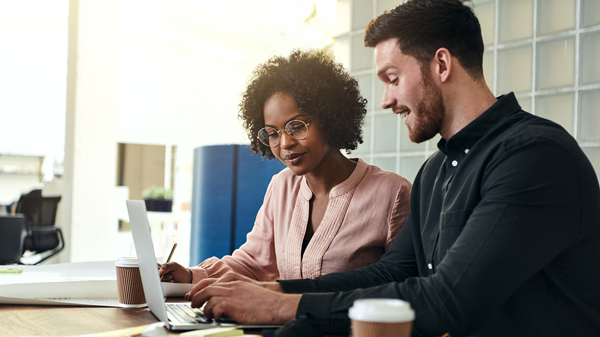 Two people working together at a computer