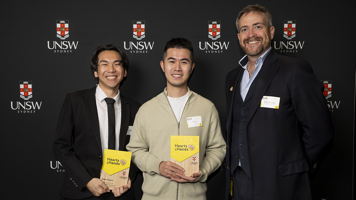 Three people, award winners William Nguyen (left) and Zili Chen (centre), with Vice-Chancellor and President Professor Attila Brungs