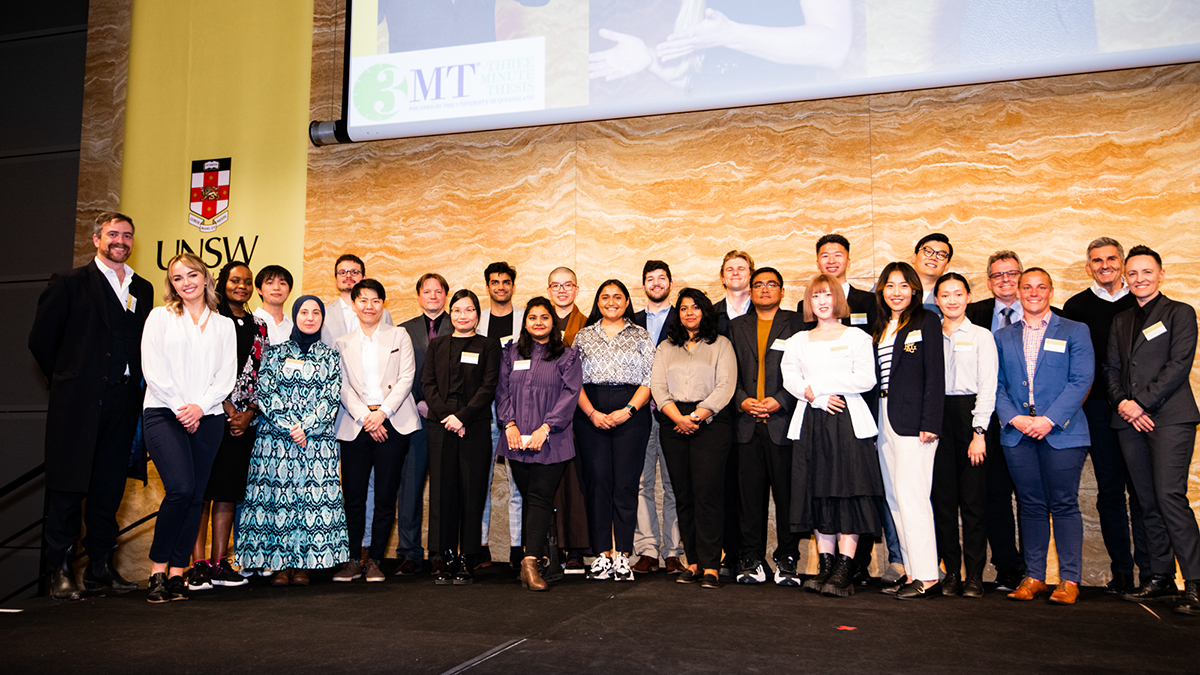 3 minute thesis participants posed on stage with the Vice-Chancellor