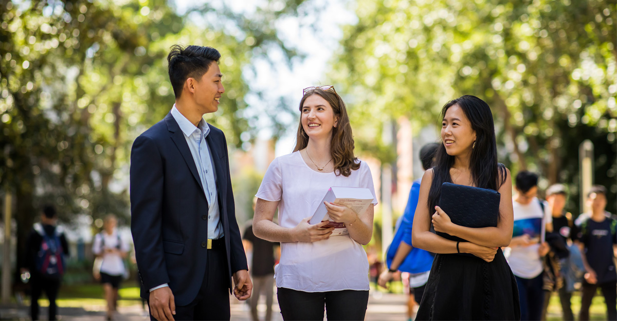 Three students walking and talking