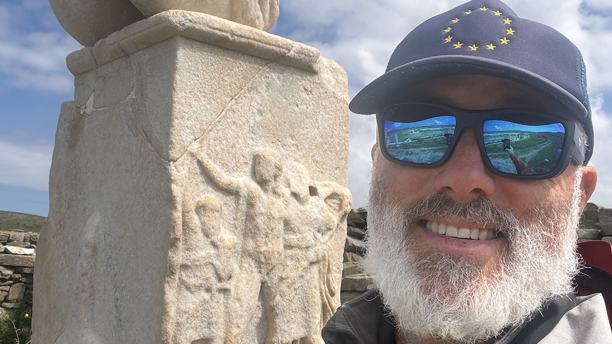Adam Fish with a statue behind him