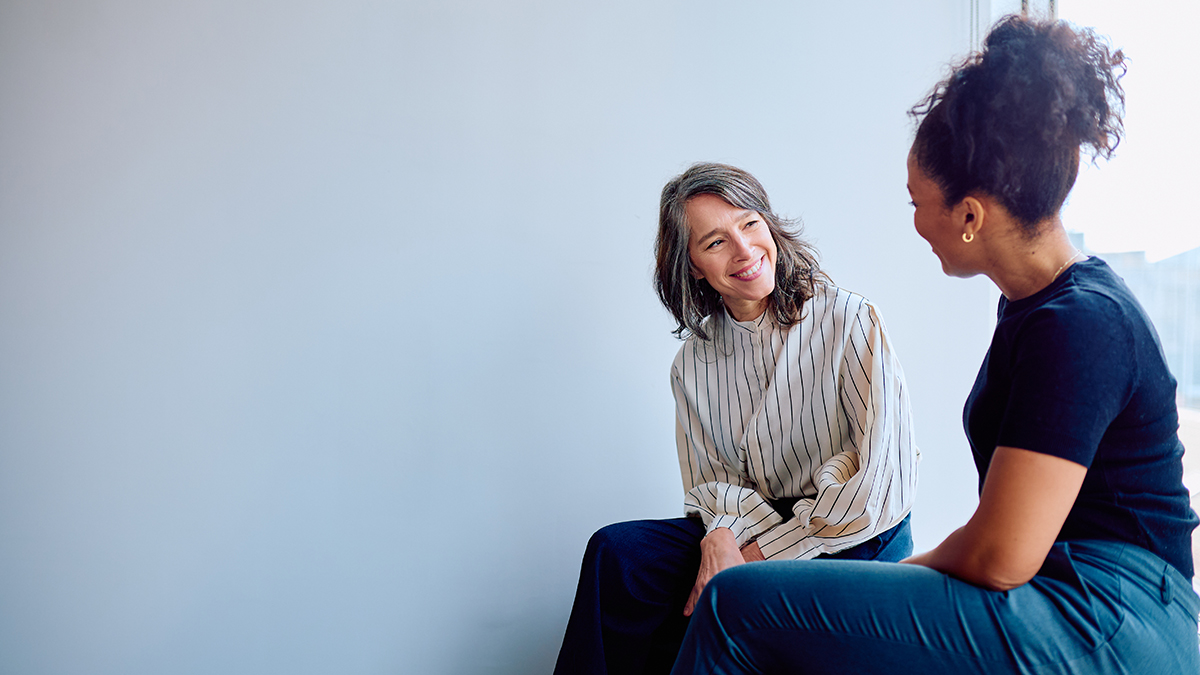 Two women smiling and talking