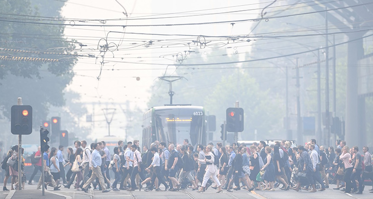 People walking across tram