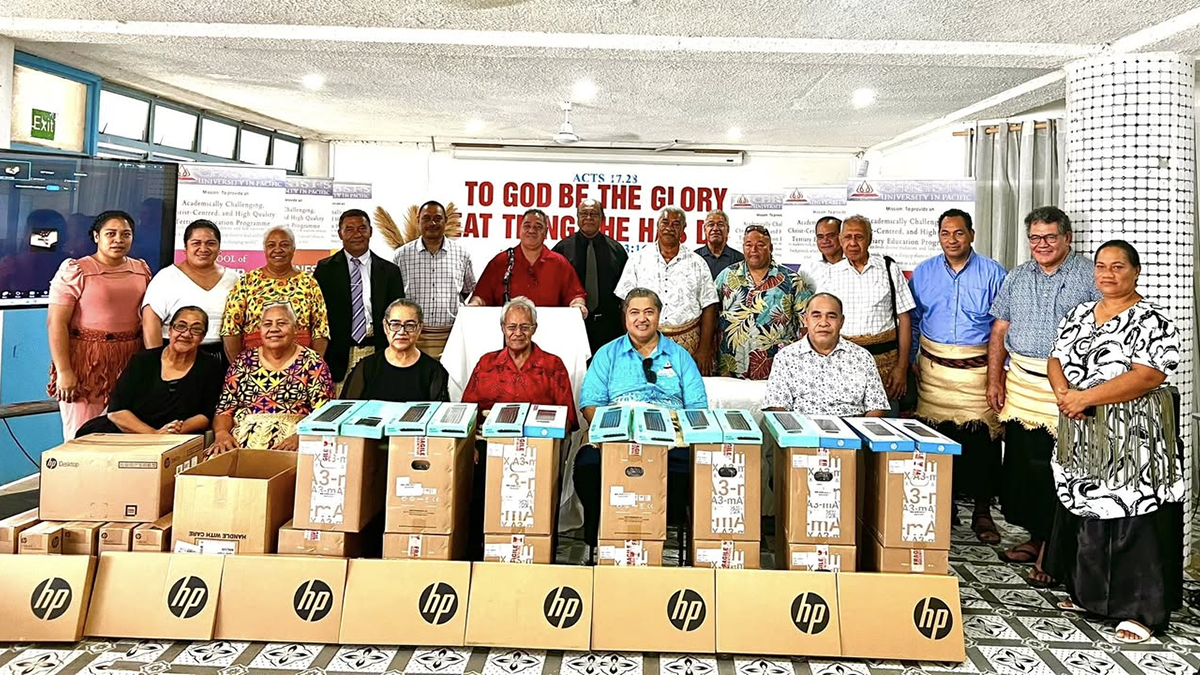 Christ’s University in Pacific staff in Tonga with computer equipment donated by UNSW