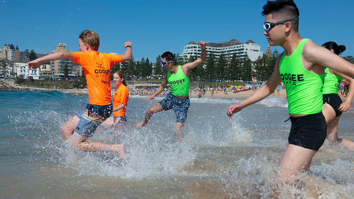Students running in the ocean