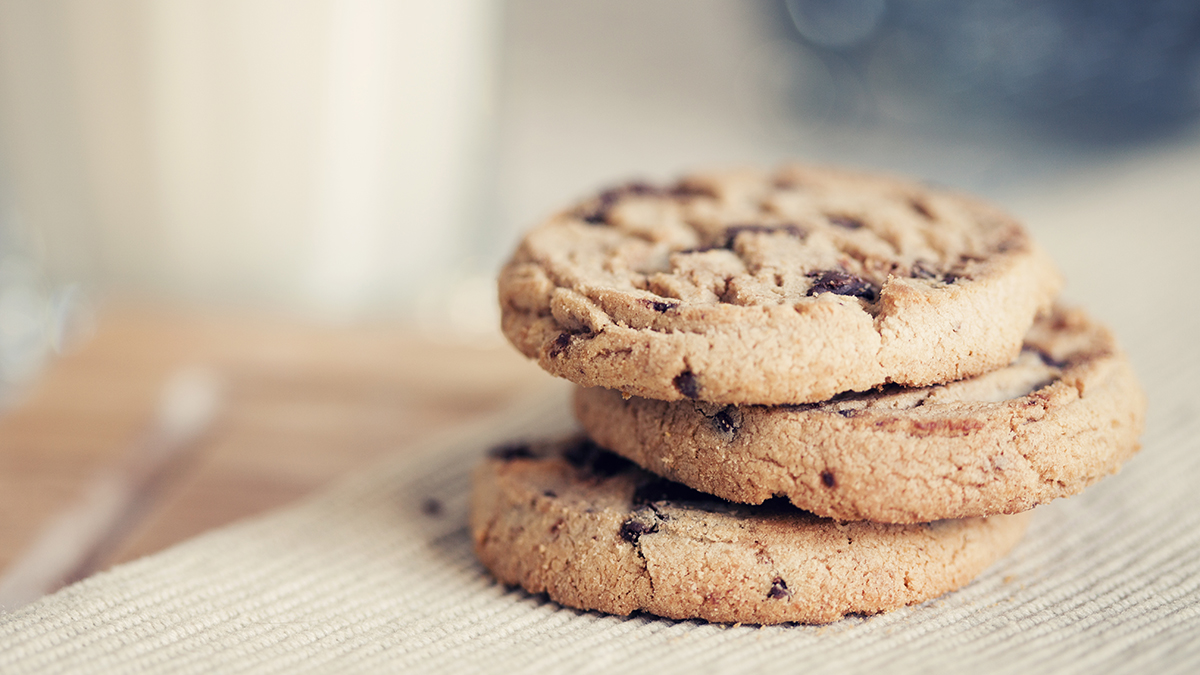 three chocolate chip cookies on a bench