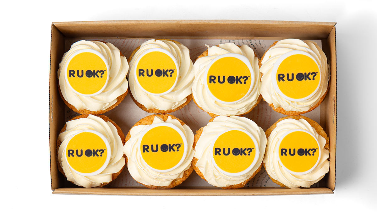 Eight cupcakes with RU OK? images on the top