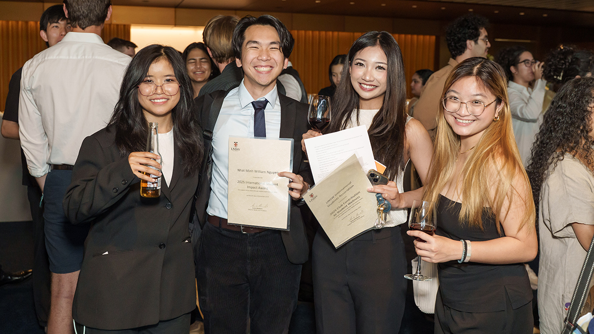 People smiling and holding certificates