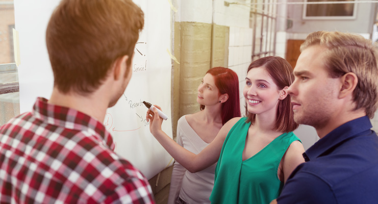 staff at a whiteboard