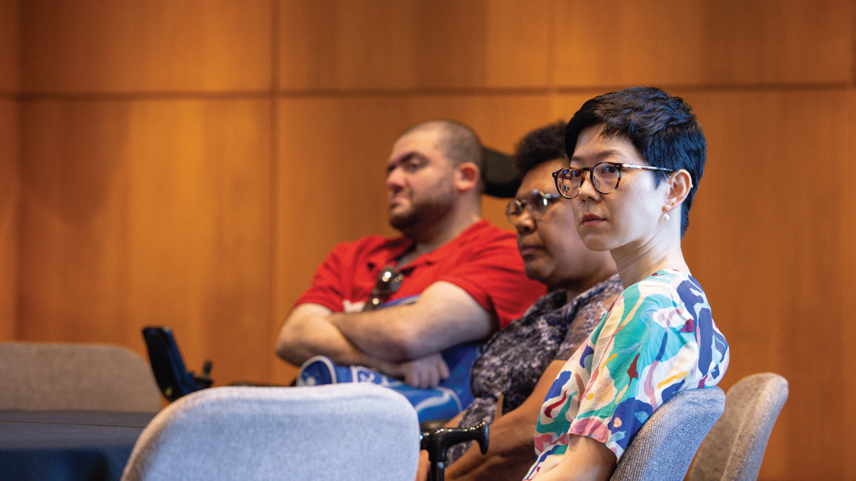 Three university staff members at a round table. 