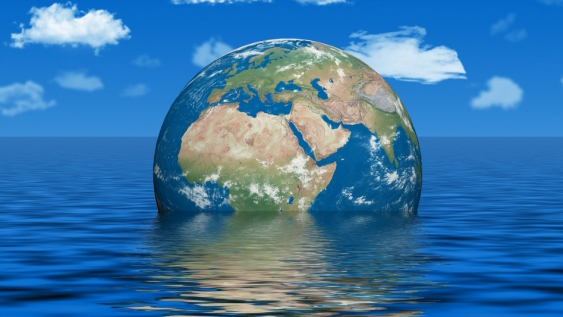 Globe half-submerged in the ocean