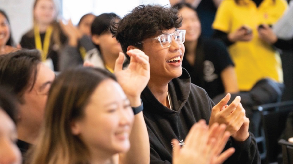 Student clapping and cheering at an event