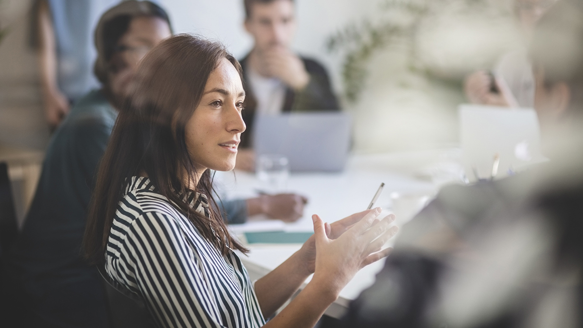 Woman sitting in a corporate meeting