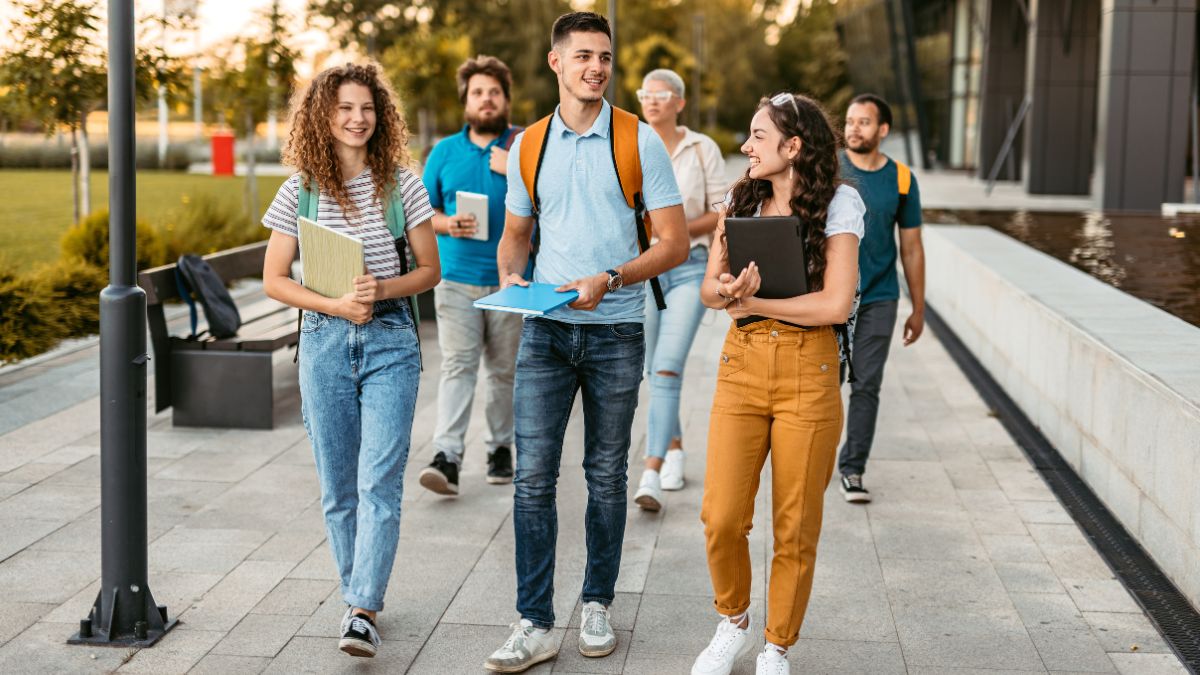 A group of students walk along a path outside