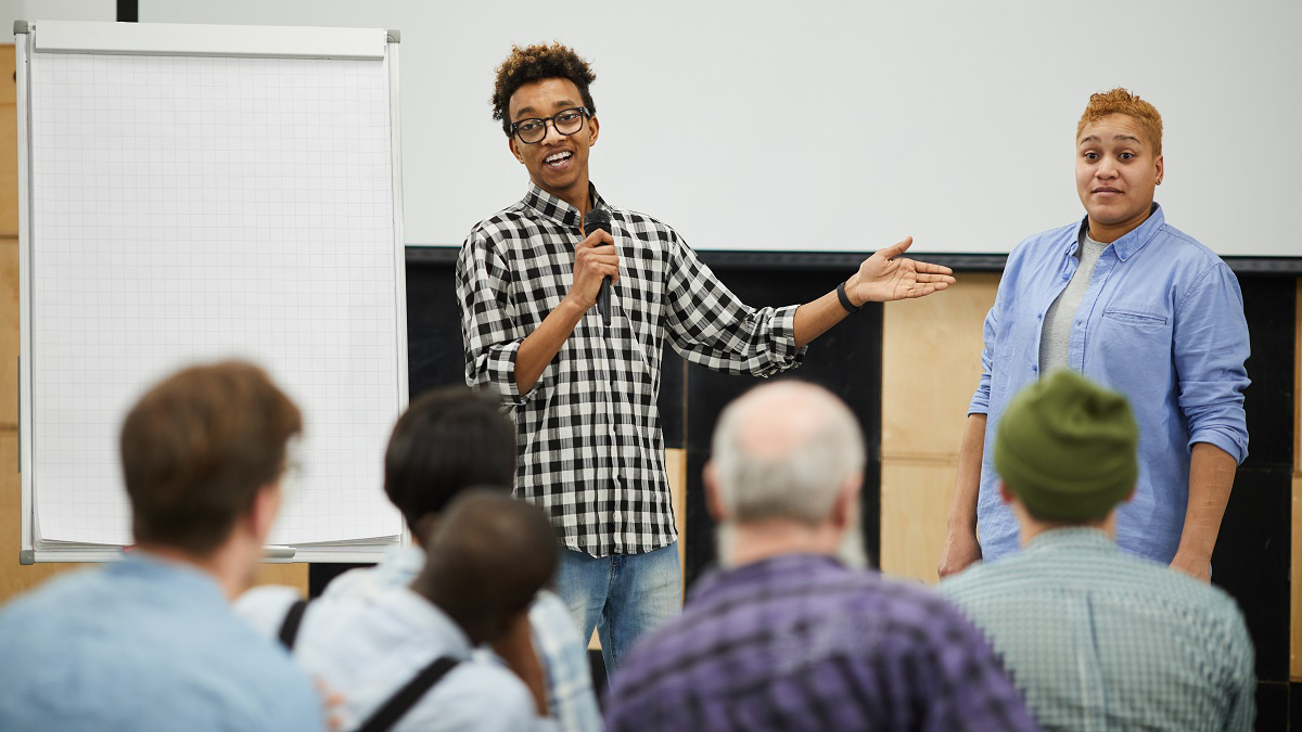 Two people presenting to an audience