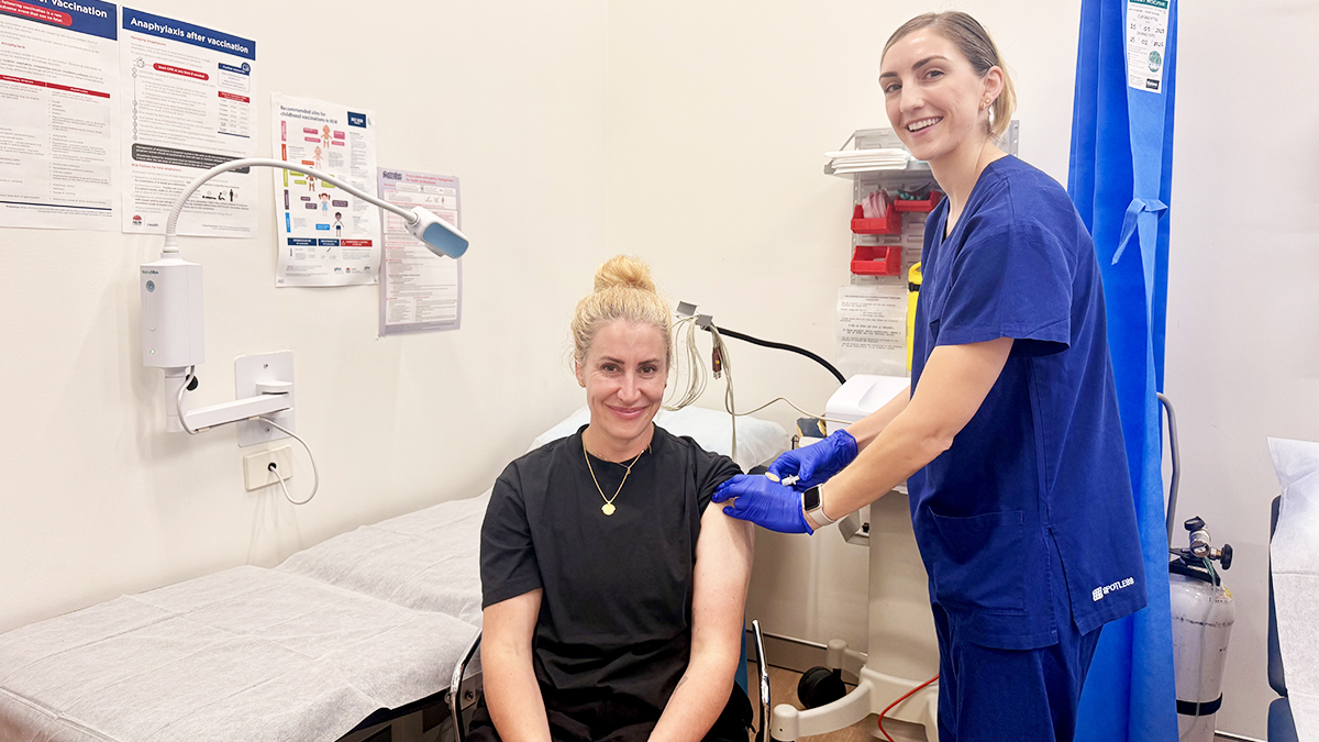 A member of staff receiving a vaccination