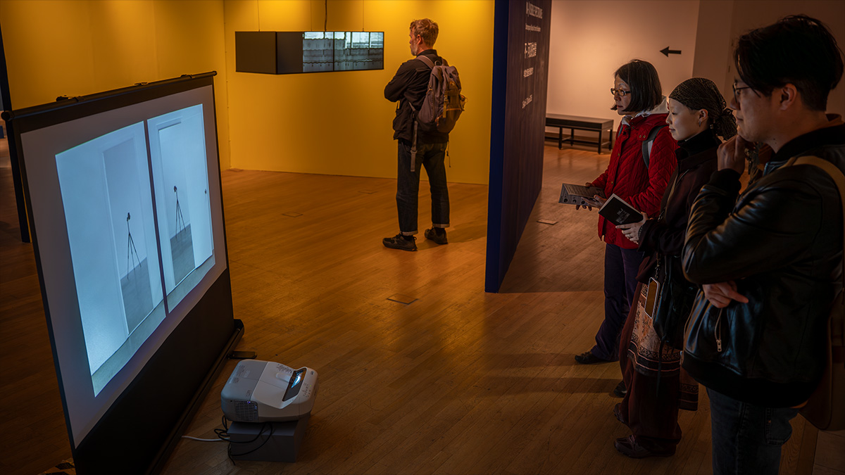 people standing around a screen
