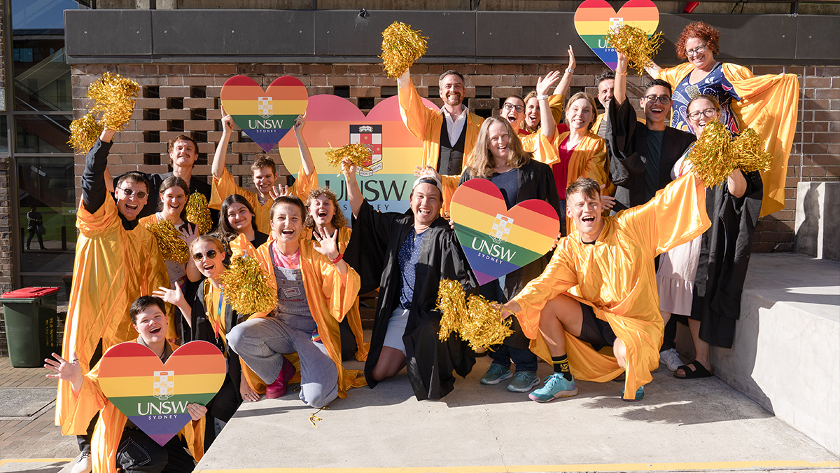 Students and the VC waving rainbow flags