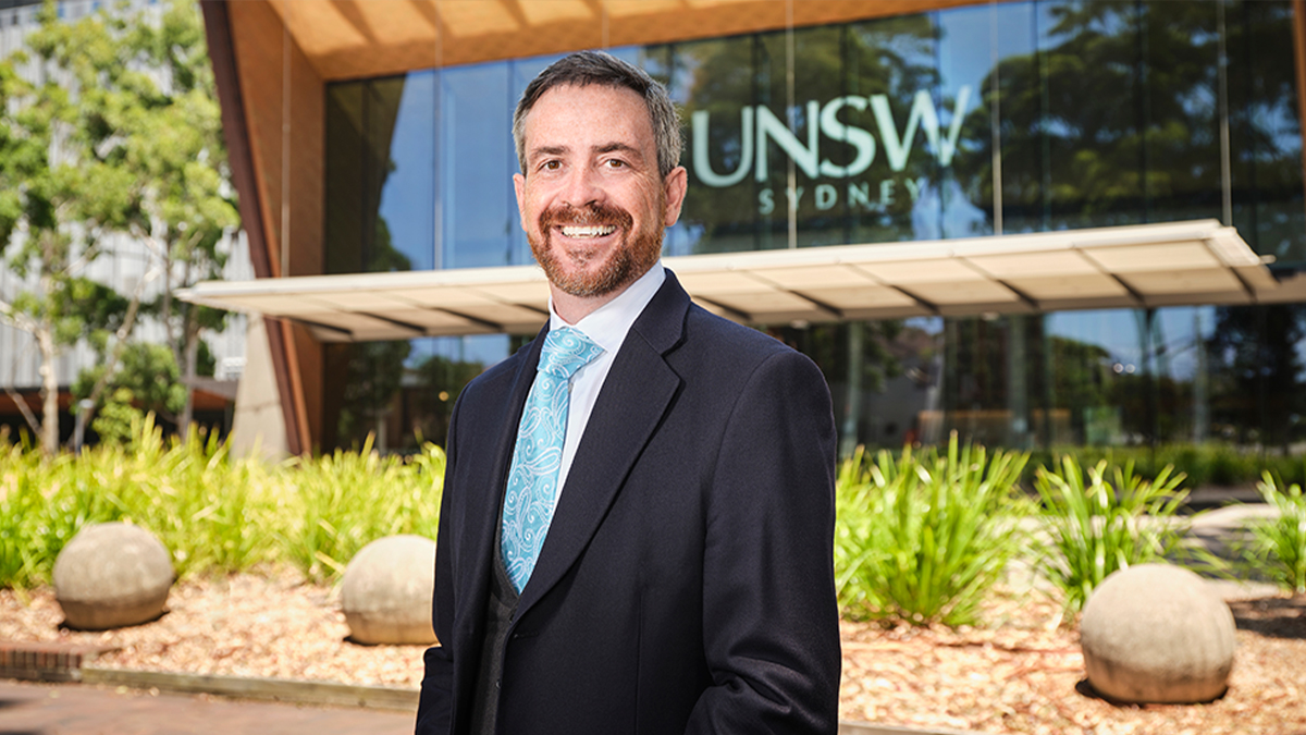 Professor Attila Brungs in front of the Clancy Auditorium 