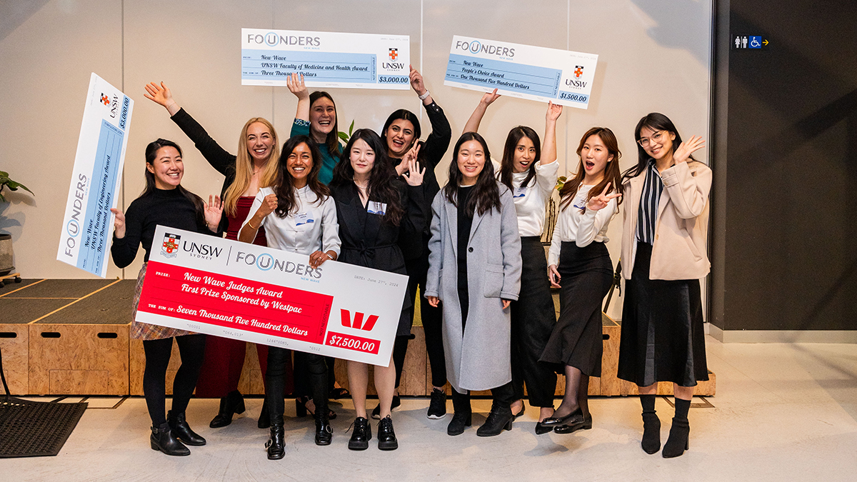 A group of women posing with a large cheque