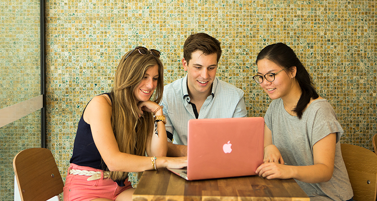 UNSW students gathered around a laptop