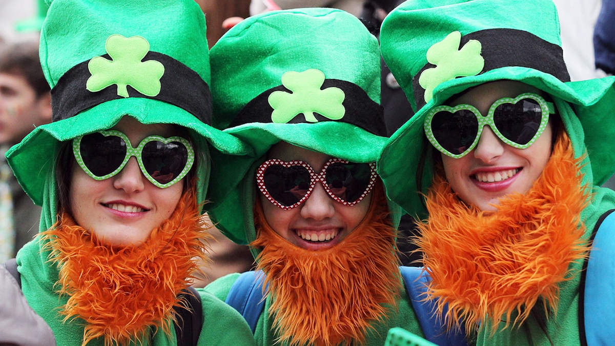 Three people enjoying Saint Patrick's Day celebrations 