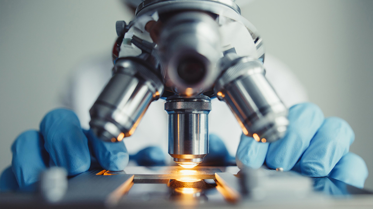 Close up of person using a microscope