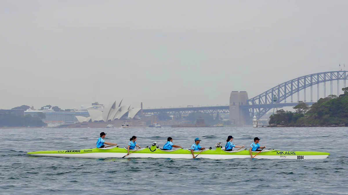 A team rowing on Sydney harbour