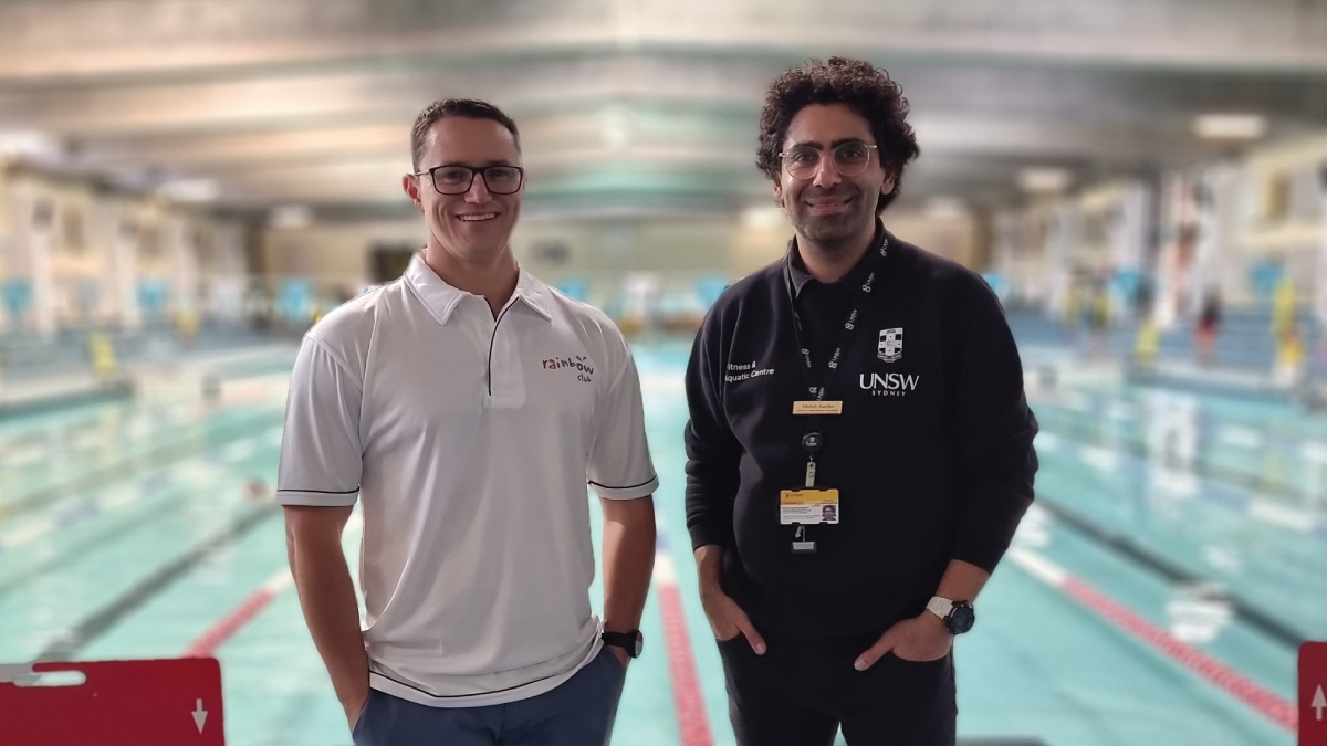 Mark Bull and Mehdi Aardin standing in front of a swimming pool. 