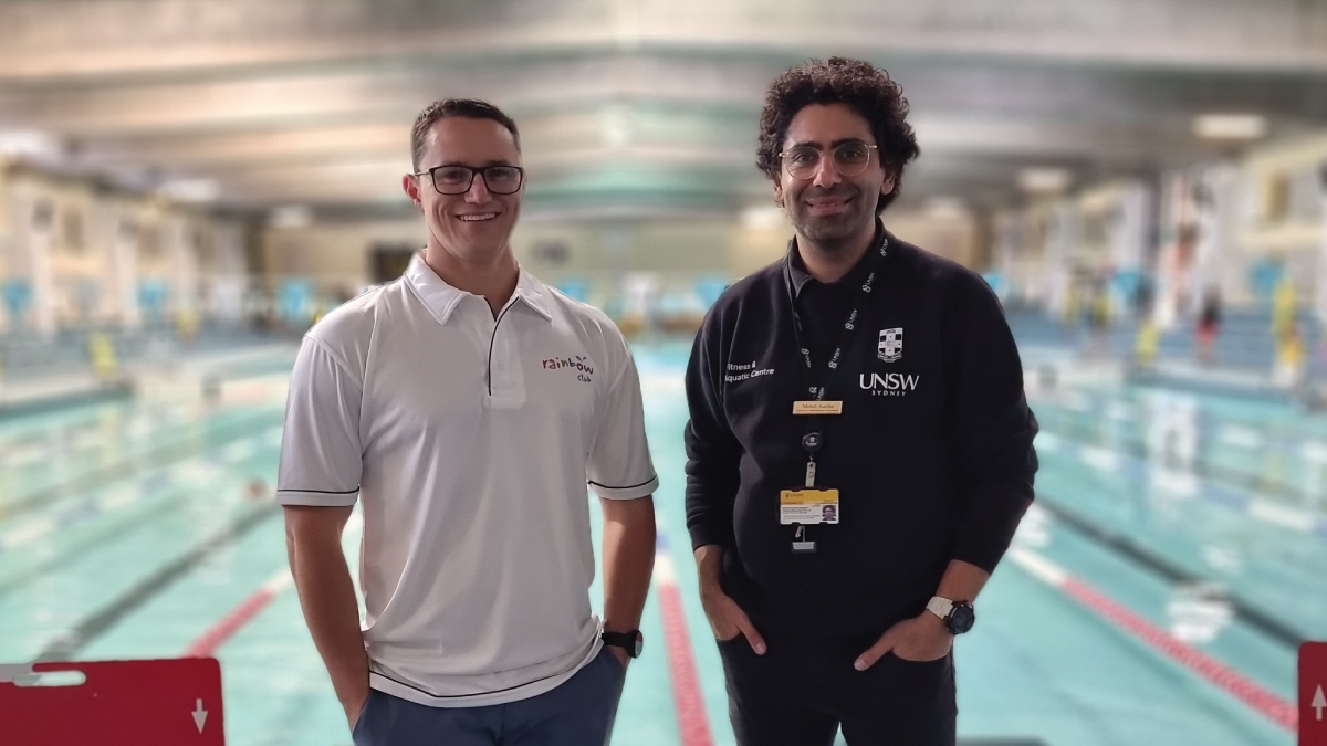 Mark Bull and Mehdi Aardin standing in front of a swimming pool.