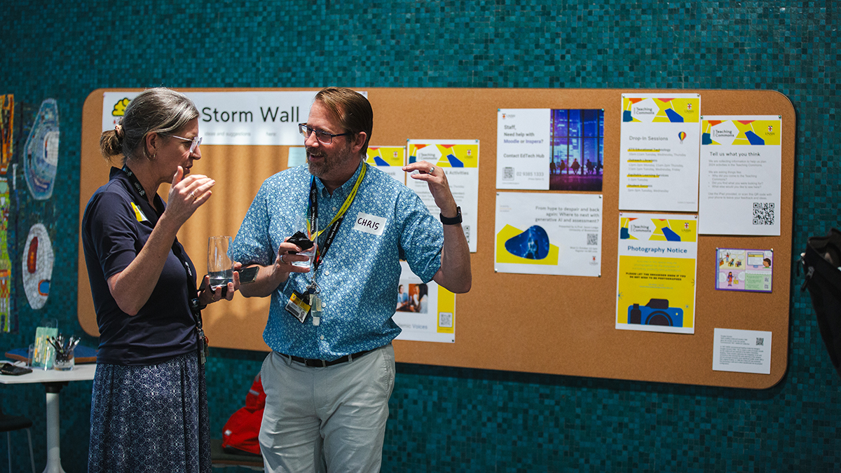 Two staff members talking in the Teaching Commons