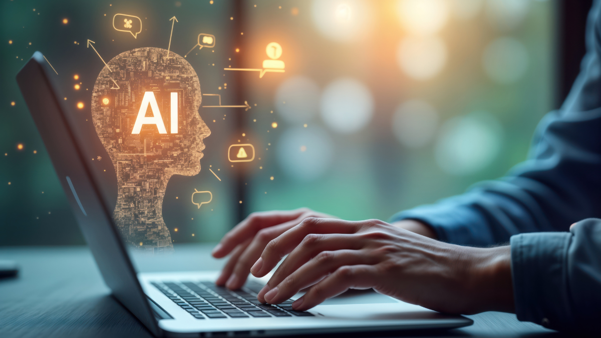 Hands typing at a laptop using AI.