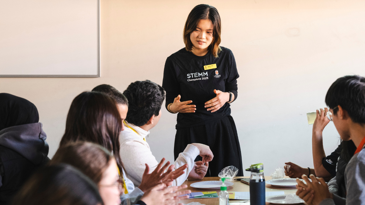 A Stemm staff talking in front of a classroom.