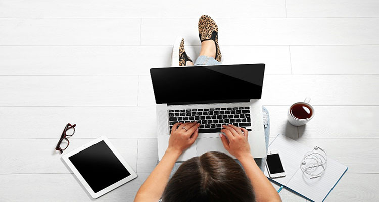 student typing on a laptop