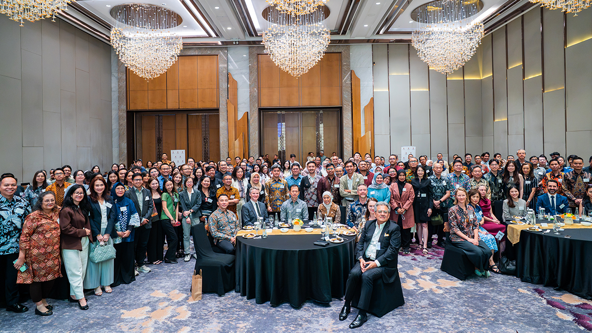 A large group of people posed in a grand room