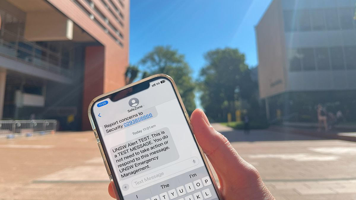 Close up of a hand holding a phone with a text alert