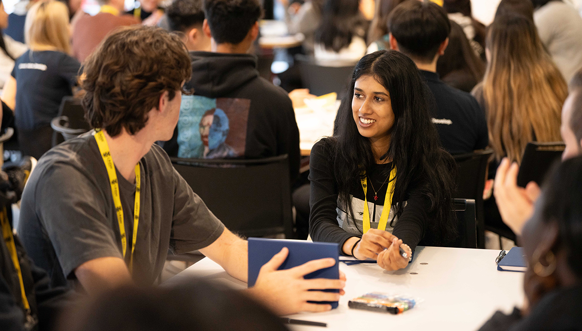 Students at a table in a busy room