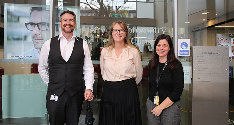 VC standing with two staff at the Optometry school