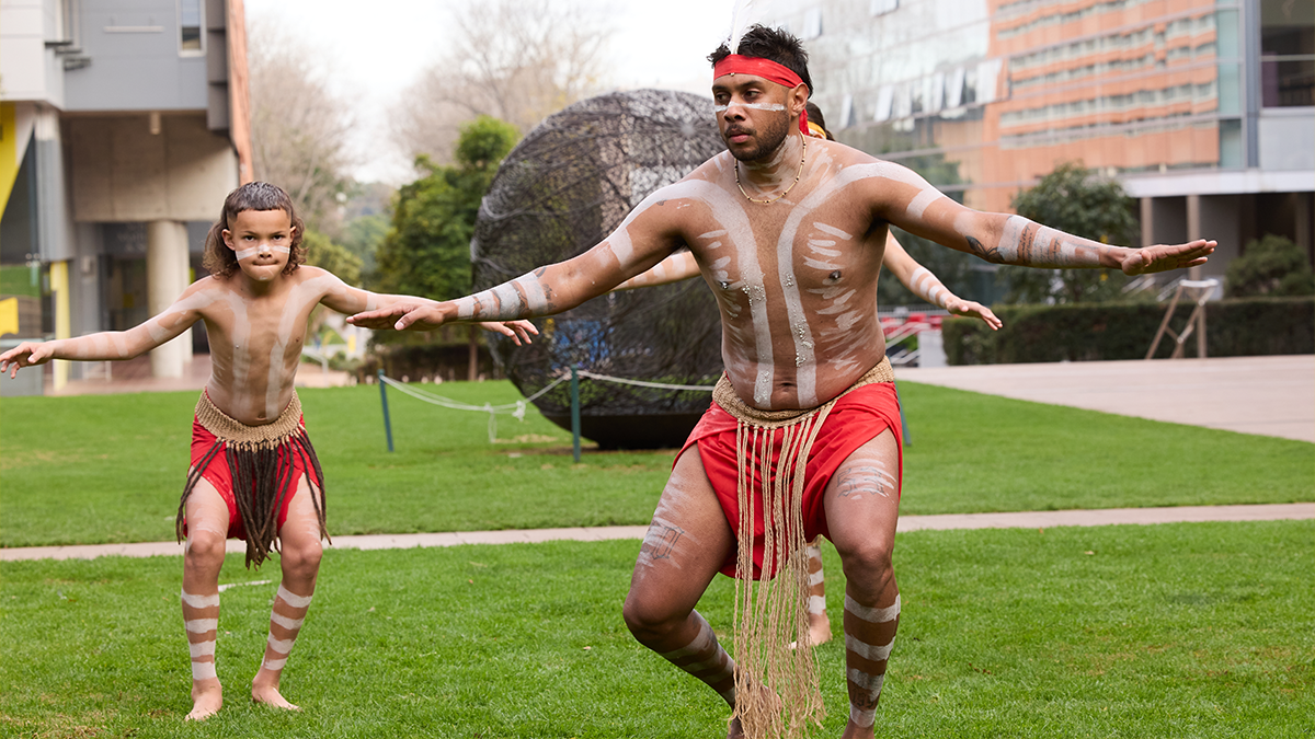 Smoking ceremony performers on Globe Lawn during NAIDOC Week