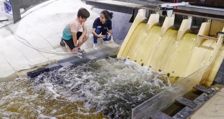 researcher at the Water Research Lab showing a child the facilities