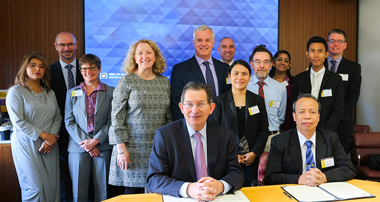 Ian Jacobs and Myint Thien (both seated) at the signing of the MOU