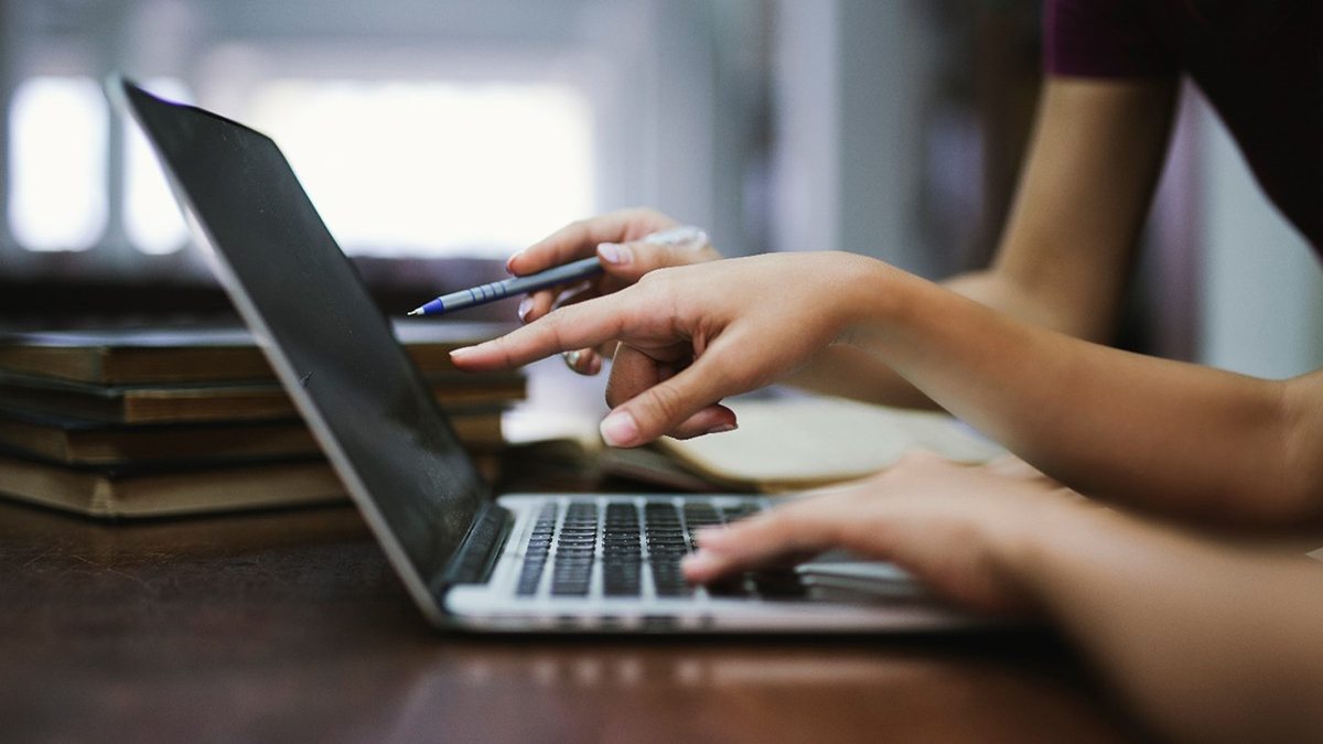 Close up of hands over a laptop