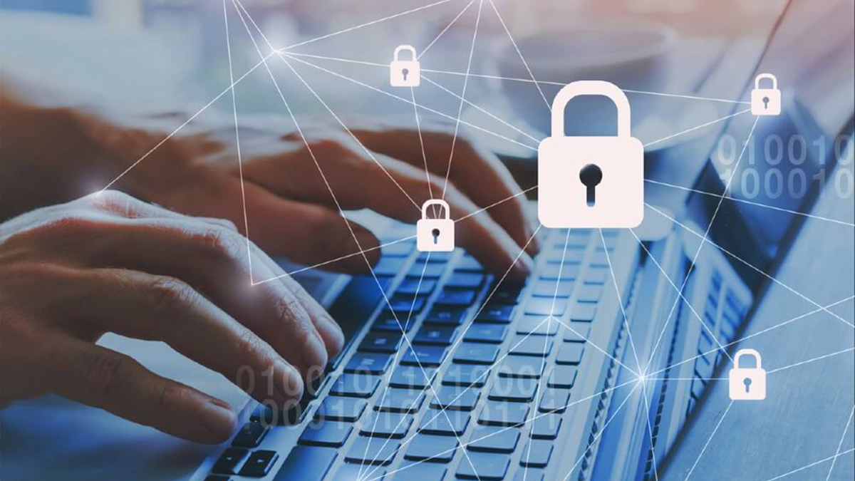 Close up of hands on a laptop overlaid with lock image