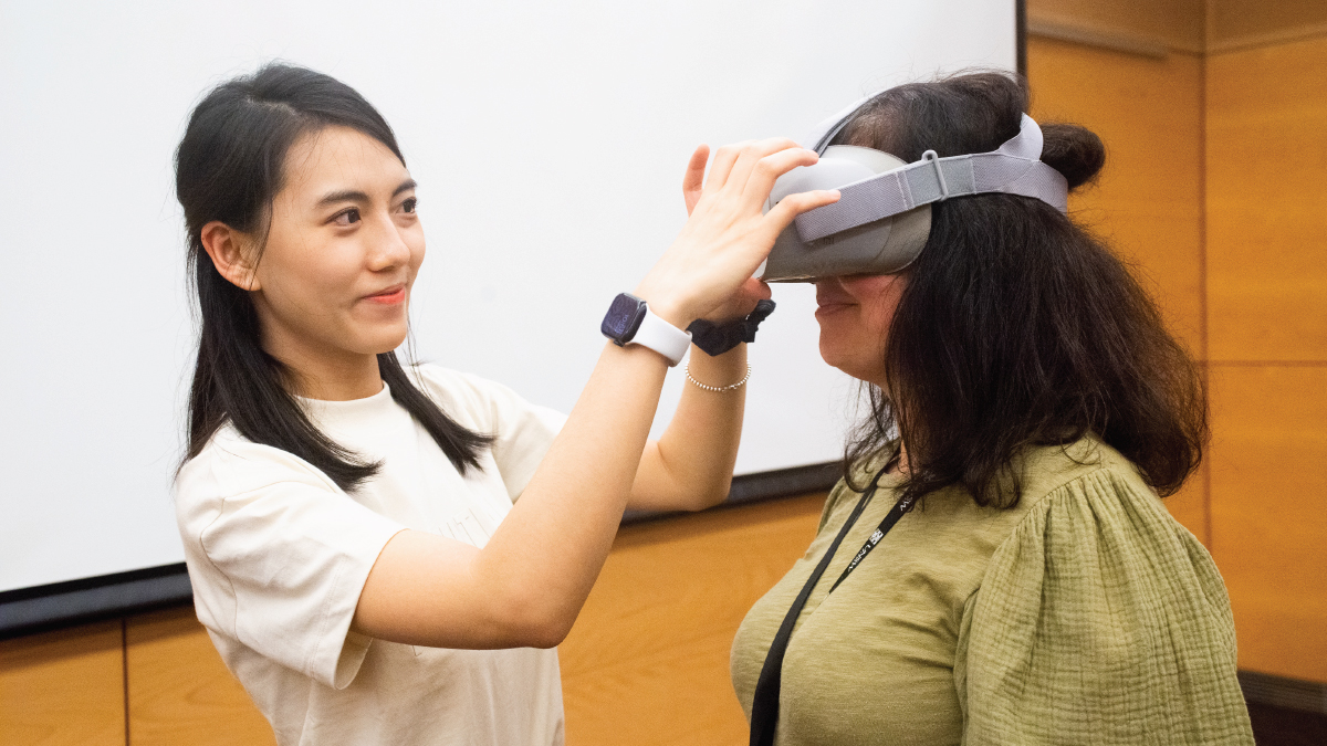 Two staff memebers using a VR device
