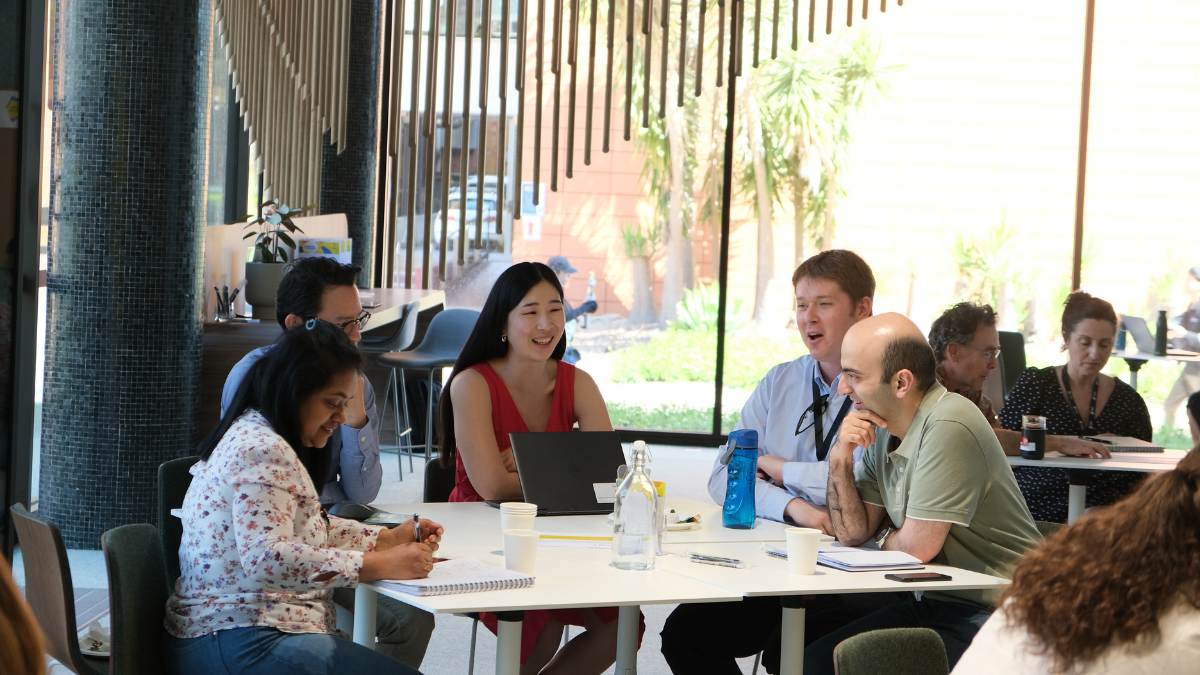 A group of people gathered at a table having a discussion