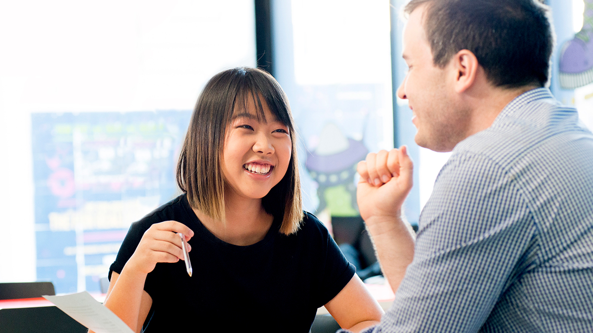 Two people chatting across a desk