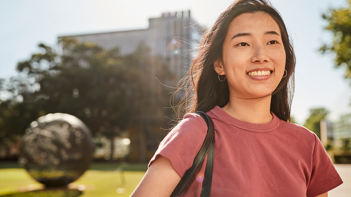 A student standing by Globe Lawn