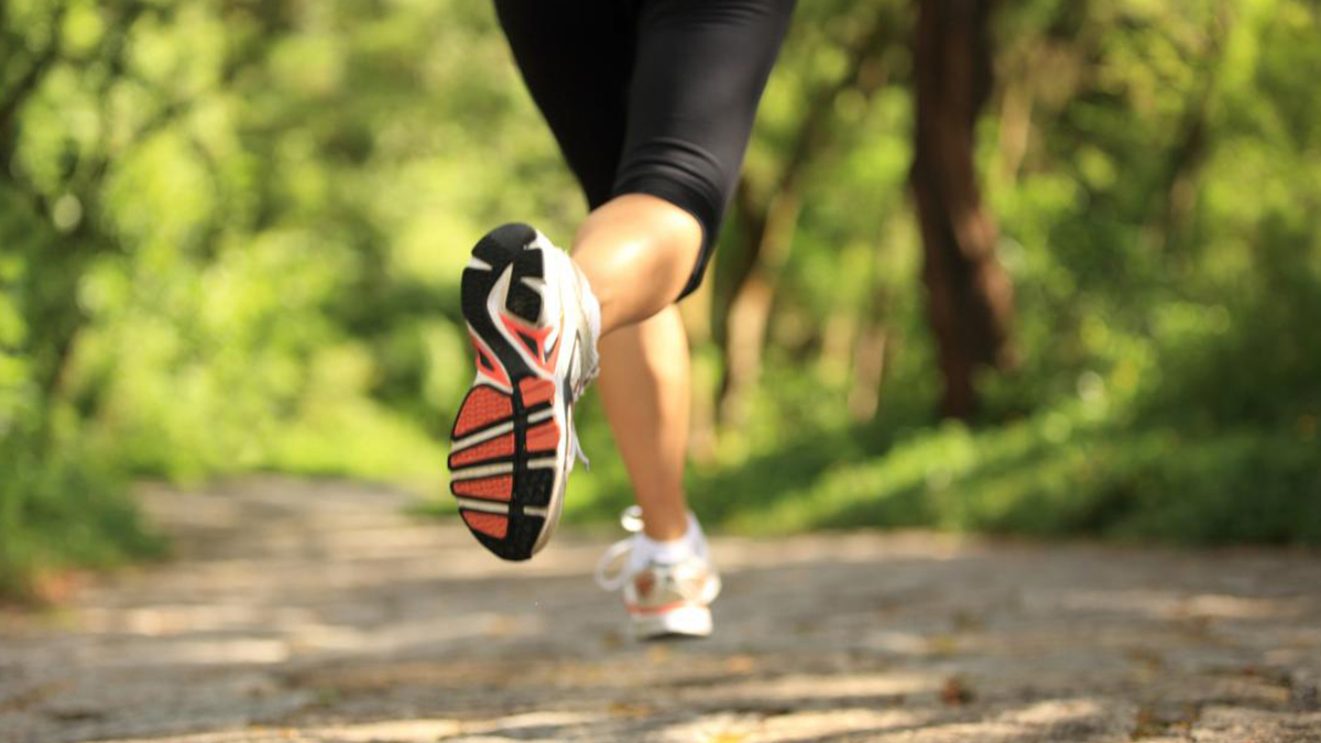 Woman jogging on forest track